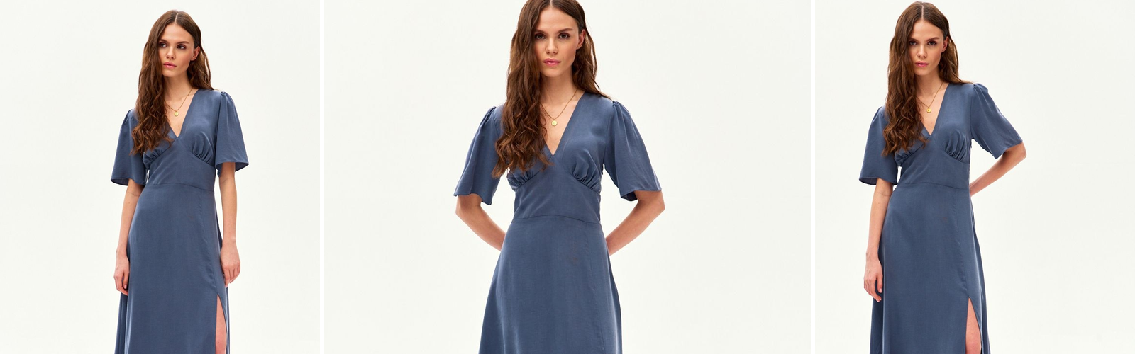Woman in a cornflower blue midi dress with a V neckline, a blue shade with a violet note.