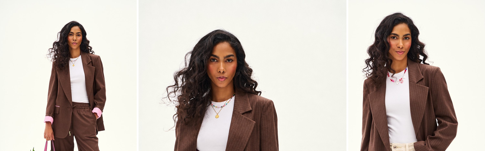 Woman in a brown pinstripe trouser suit, studio photograph