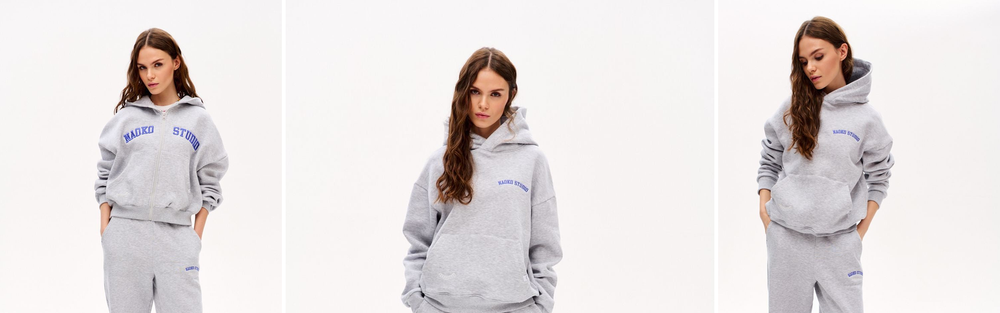 Woman in grey joggers and a matching hoodie, studio photograph