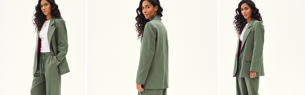 Woman in an olive suit with a blazer and wide trousers, an autumn palette of earthy shades.
