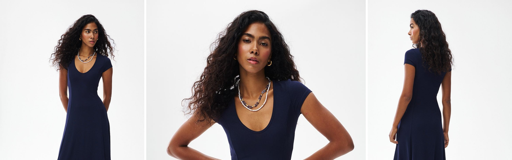 Woman in a navy ribbed knit midi dress, studio photograph